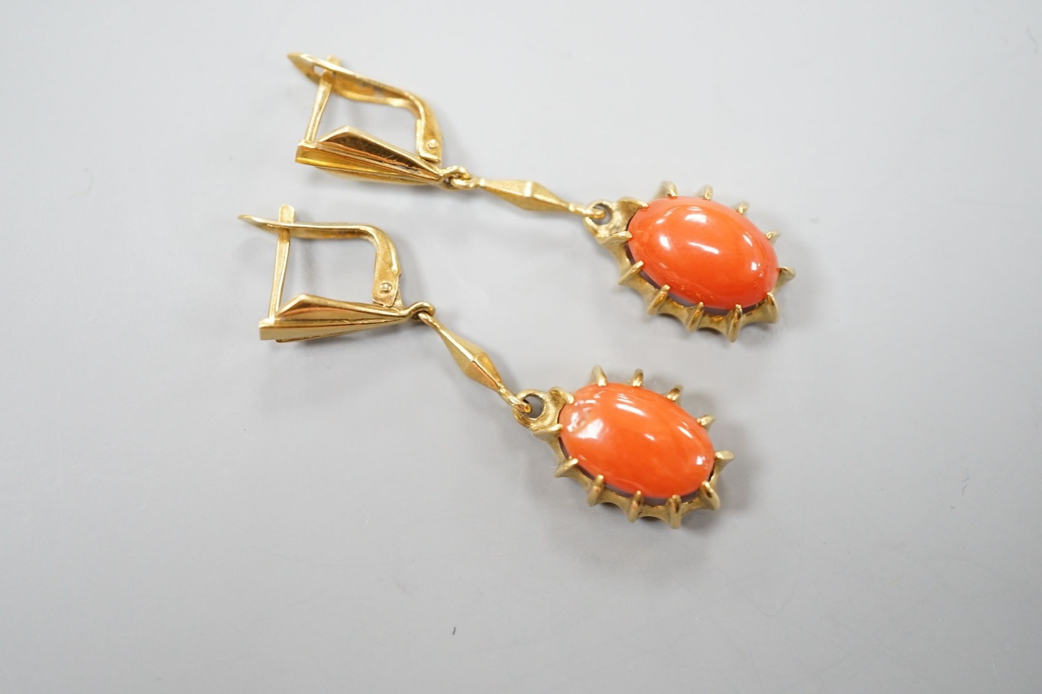 A pair of 18k and oval coral bead set drop earrings, 39mm, gross weight 6.8 grams.